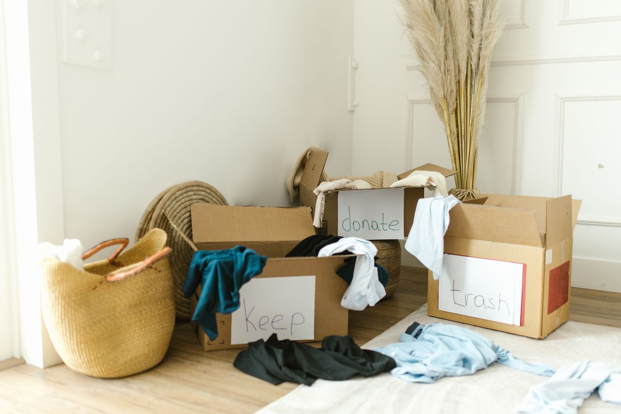 digital Cardboard boxes labeled Keep, Donate, and Trash for home decluttering.
